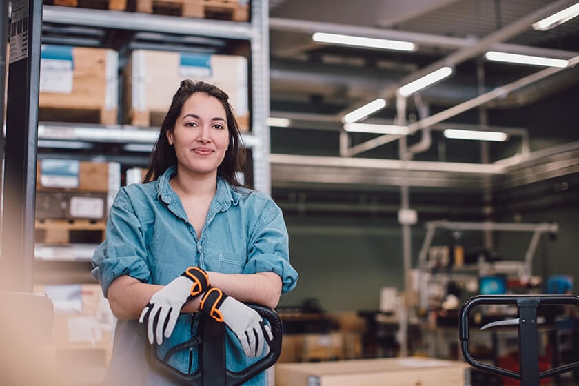 woman wearing gloves in warehouse woman wearing gloves in warehouse