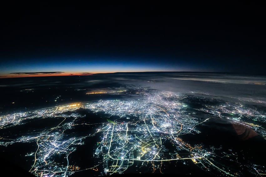 View of one side of the earth at night with lights lit up 