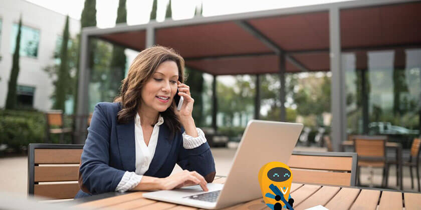 Workplace by Facebook page image Photo of a woman talking on the phone and working on a computer.