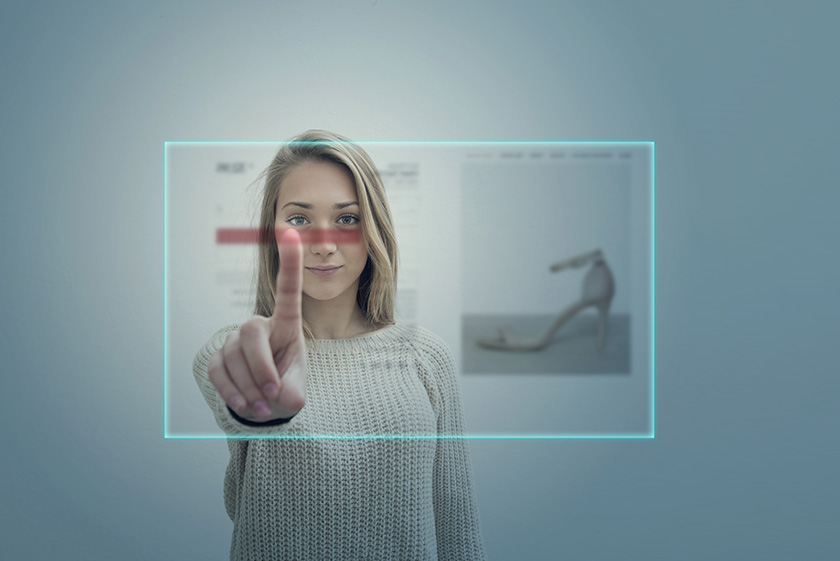Young woman using virtual reality simulator touching screen for make a shopping online