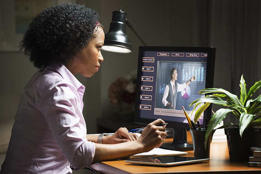 Estudiante en el ordenador mirando una lección de eLearning en pantalla